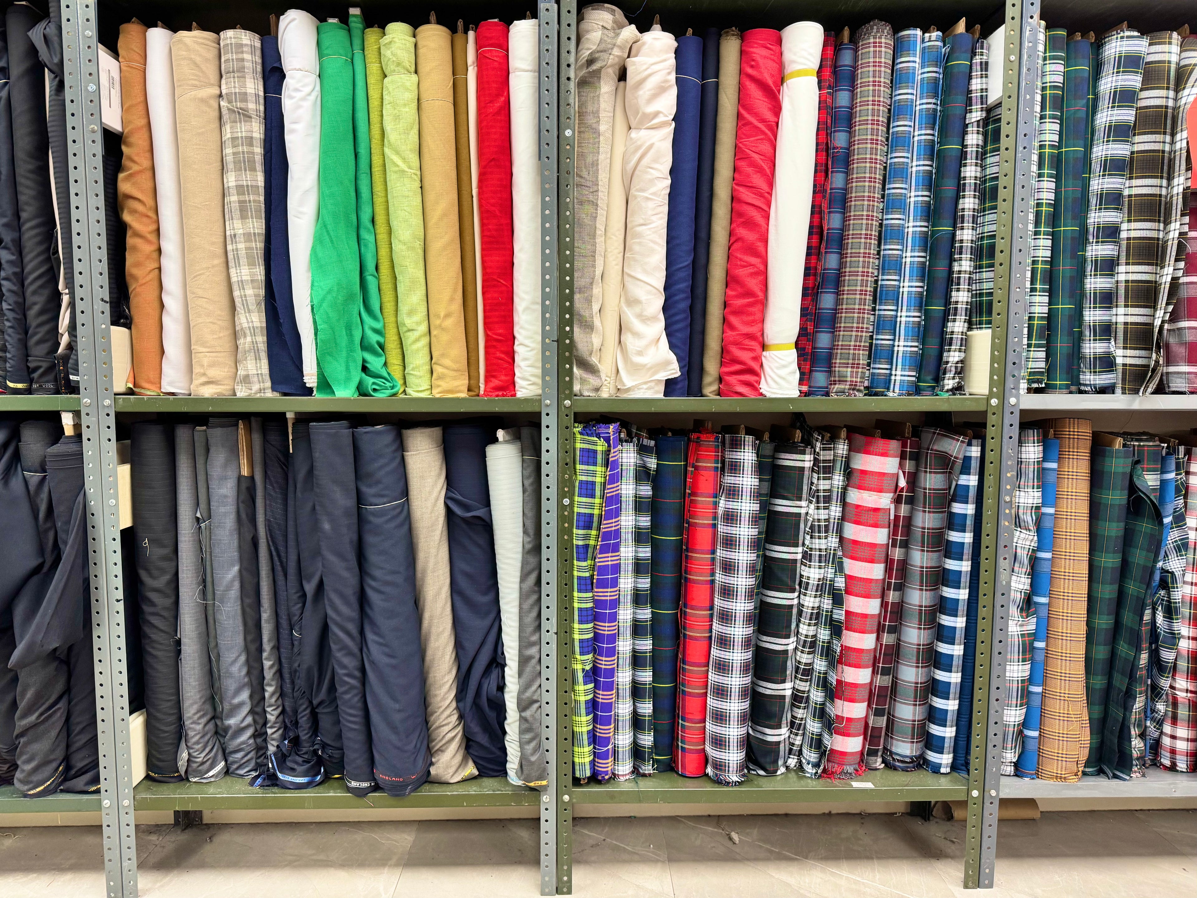 Plaid and solid uniform fabrics on display